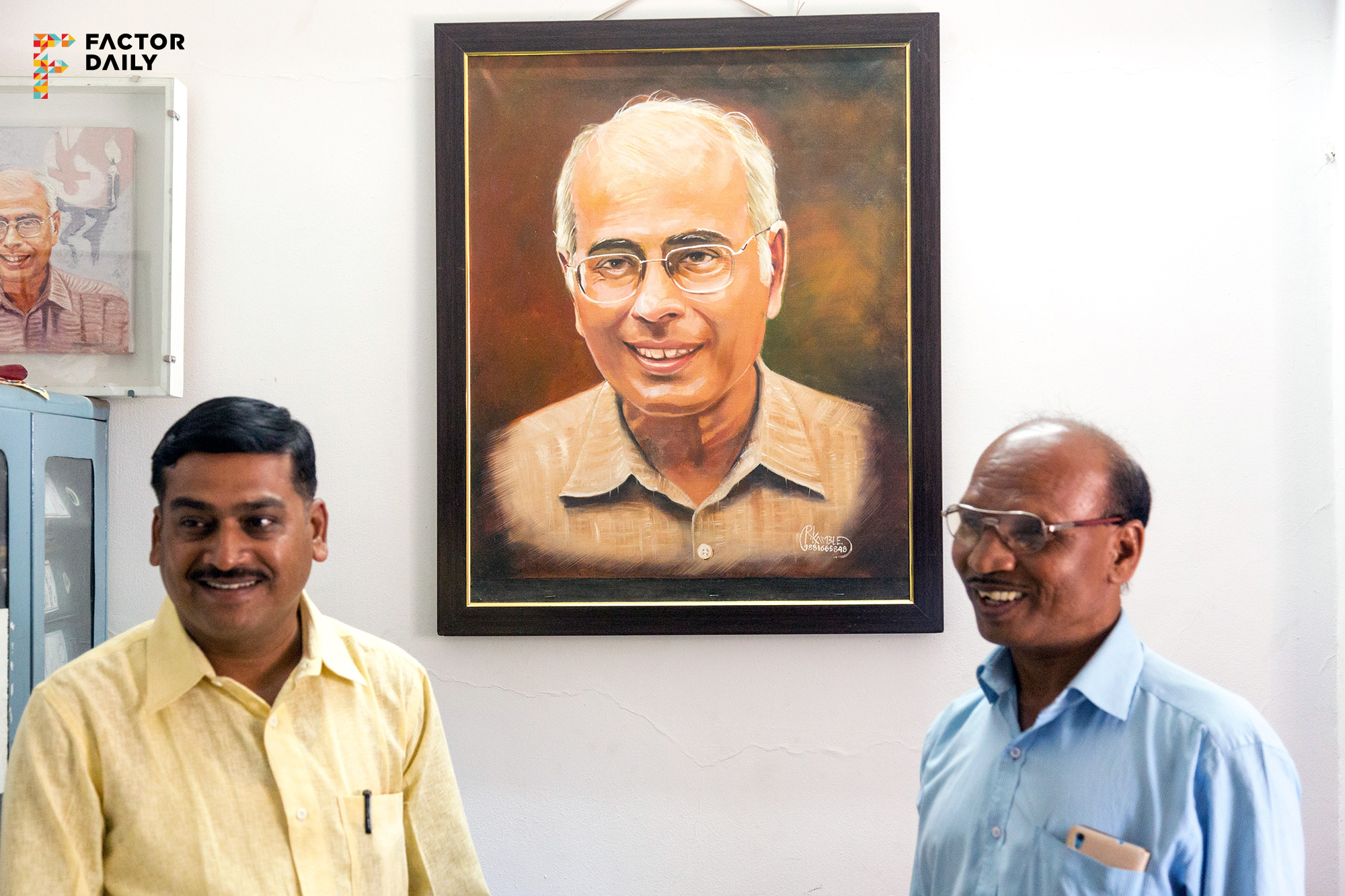 Prashant Potdar (left) and Bhagwan Randive (right) standing in front of a portrait of Dr Narendra Dabholkar